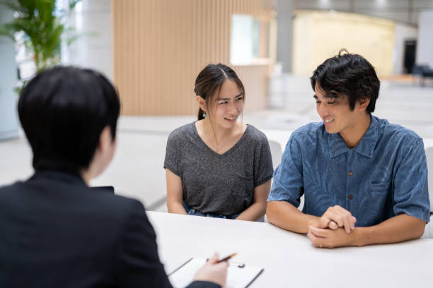 istock Asian married couple consulting with agent 1313782677