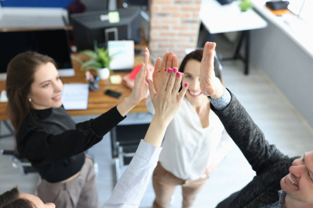 istock Business people happily give each other five in office 1313784372