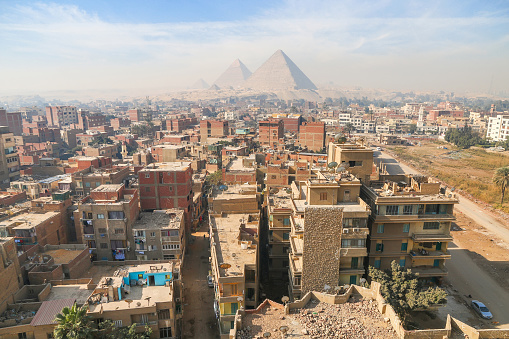Aerial view of the living quarters of Giza at the background of Pyramids of Egypt