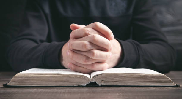 istock Caucasian man praying in the dark room. 1313784831