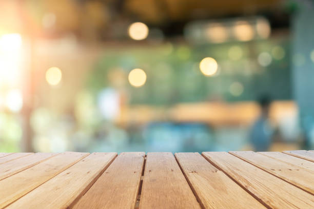 istock Selective focus of wooden table with blur coffee and restutant cafe with customers background. 1313785669