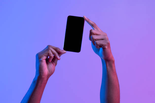 istock Two African American Male Hands Holding Smartphone With Black Screen, Mockup Image 1313785973