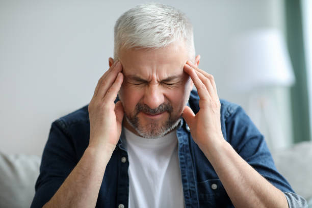 istock Senior man having headache, touching his temples 1313786747