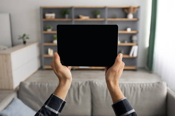 istock Male Hands Holding Tablet With Blank Screen Standing At Home 1313786822