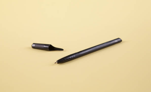 istock Black pen on an isolated yellow background. 1313787197