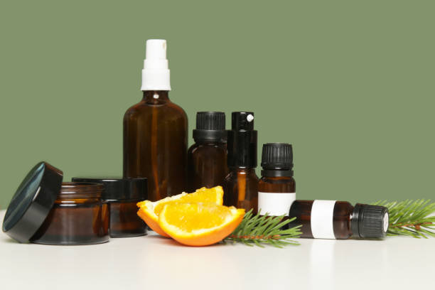 istock Various brown glass cosmetics bottles on green background 1313787884