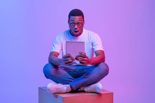 istock Amazed African Student Guy Sitting With Digital Tablet Looking At Screen 1313788604