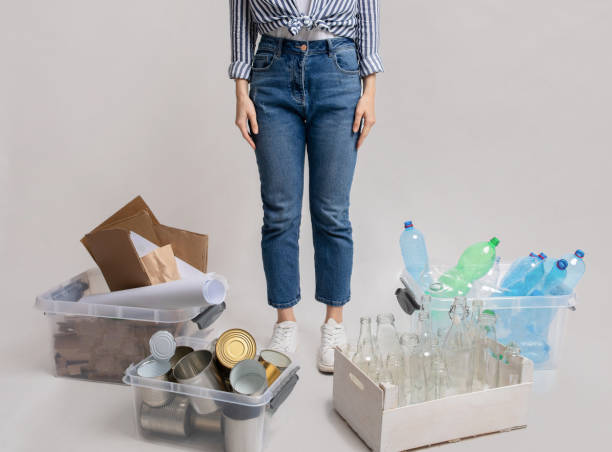 istock Cropped Image Of Woman Standing Next To Boxes With Different Sorted Garbage 1313789059