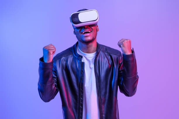 istock Overjoyed Black Man In VR Glasses And Leather Jacket Playing Video Games 1313789543