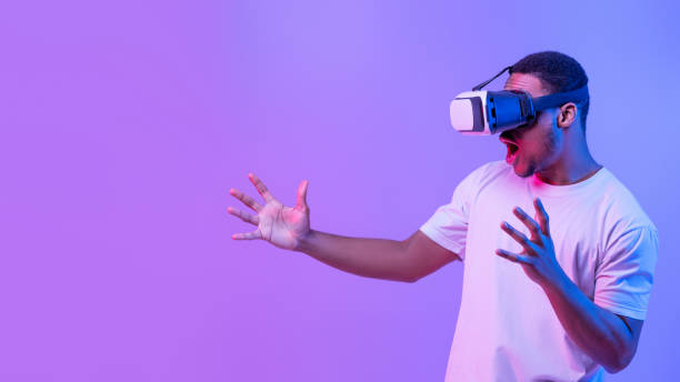 istock Virtual Gaming Concept. Portrait Of Excited Black Male Enjoying Augmented Reality Experience 1313790118