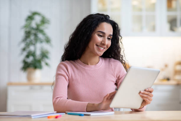 istock Distance Learning. Happy Young Woman Study With Digital Tablet In Kitchen 1313790411