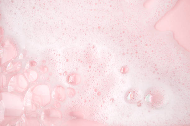 istock White foam bubbles texture on pink pastel background, copy space, banner for loundry, cleaning service, bathroom concept, clean, wash - liquid soap, shower gel, shampoo 1313790432