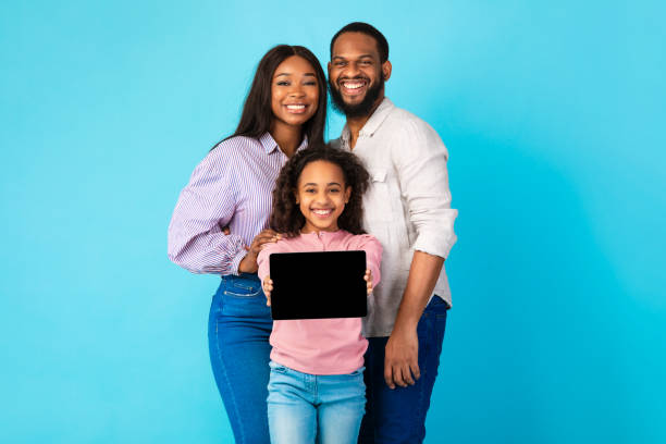 Black family showing blank empty tablet screen for mockup