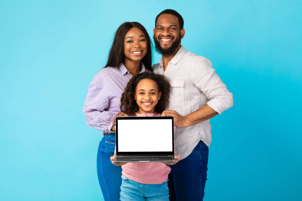 istock Black family showing blank empty laptop screen for mockup 1313790698