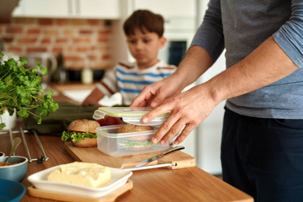 close up of father making lunch box for son - child human hand sandwich lunch box imagens e fotografias de stock