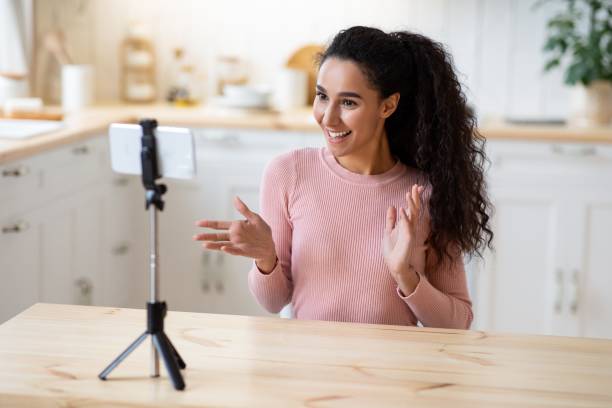istock Vlogging Concept. Young Influencer Lady Using Smartphone In Kitchen, Recording Video Content 1313791936