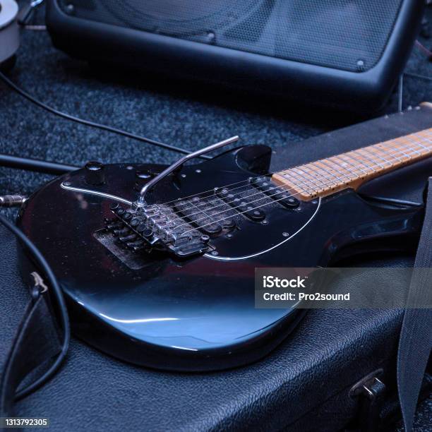 Black Electric Guitar With Tremolo On A Hard Case Stock Photo - Download Image Now - Guitar, Guitar Case, Abalone