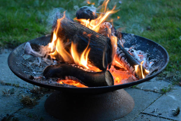 fire pit on patio made of black granite tiles. - fire pit campfire bonfire fire imagens e fotografias de stock