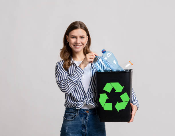 istock Positive Millennial Woman Holding Black Container With Empty Plastic Bottles For Recycling 1313792551