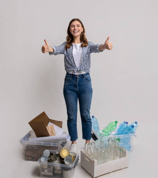 istock Materials Recycling Concept. Happy Woman Standing Next To Containers With Different Waste 1313793622