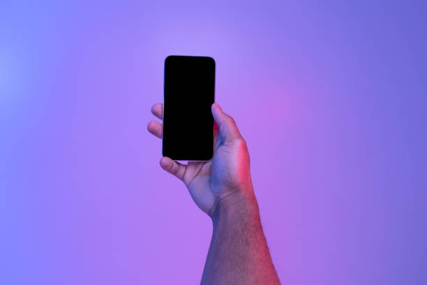 istock Mobile technologies. Black male hand holding cellphone with blank screen 1313793631