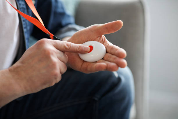 istock Man pushing panic button on emergency equipment for elderly people 1313794540