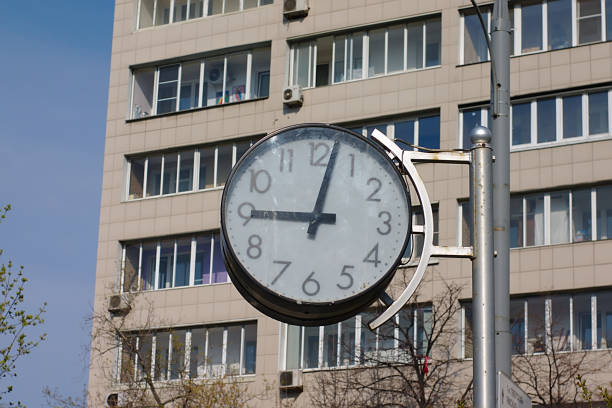 Madrid, Spain. Low angle view of a train station clock against a cloudy sky.