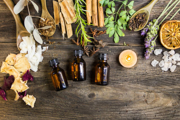 variety of flowers, herbs, candles and essences for aromatherapy, on rustic wood set of aromatic incense and natural flowers and herbs on rustic wood perfume counter stock pictures, royalty-free photos & images