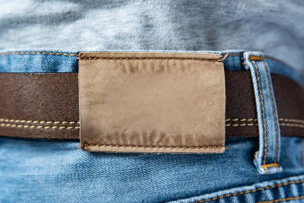 Photo of Leather label on the back of blue jeans