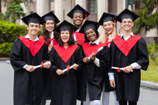 istock Diverse international students with diplomas celebrating graduation, smiling at camera 1313795348