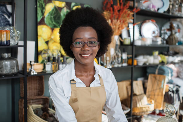 istock Smiling confident African female worker, posing at camera during work at decor shop 1313796155