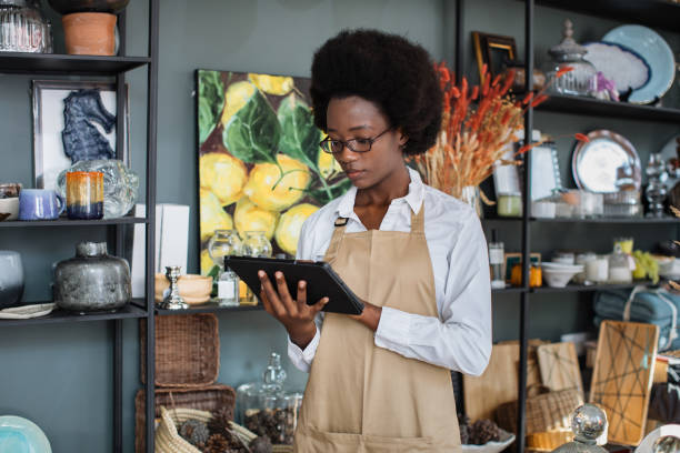 istock Afro american woman using tablet for inventory at shop 1313796750