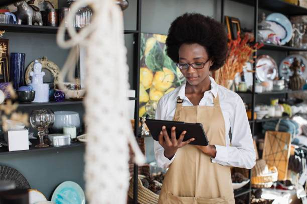 istock Afro american woman using tablet for inventory at shop 1313796791