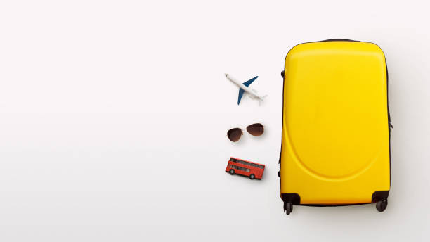 istock Plane, glasses and red bus next to yellow suitcase 1313797066