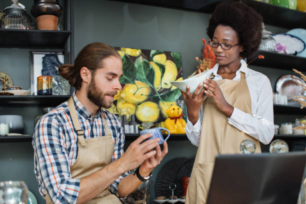 istock Two workers creating online catalogue of goods at store 1313797608