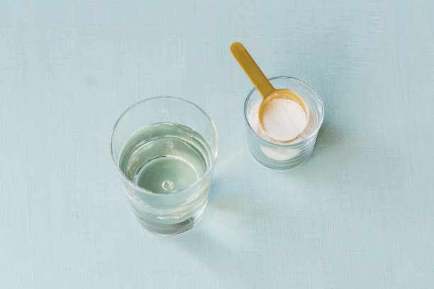 istock Glass with collagen dissolved in water and collagen protein powder on a light blue table. Healthy lifestyle concept. 1313797985