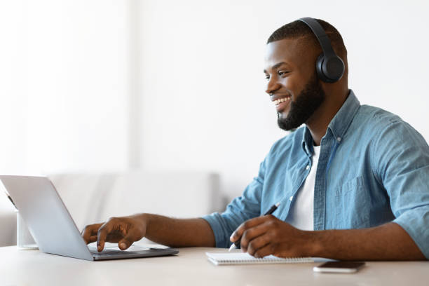 istock Online Education. Happy Black Guy Study In Internet, Watching Webinar On Laptop 1313799385