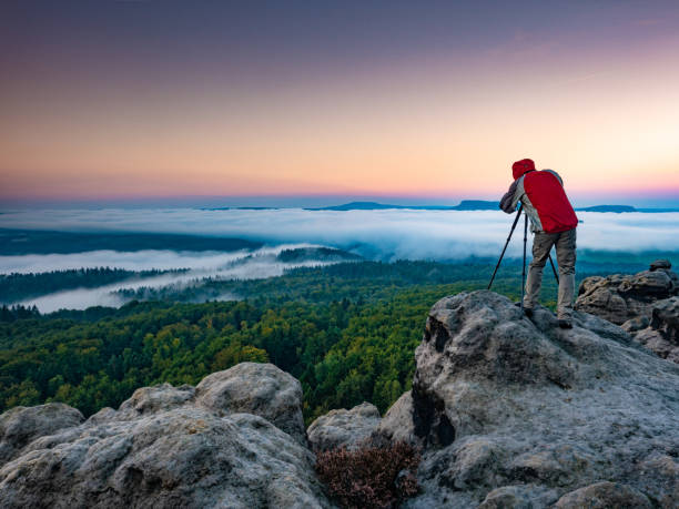 istock Man Standing On Rock Against Sky 1313799934