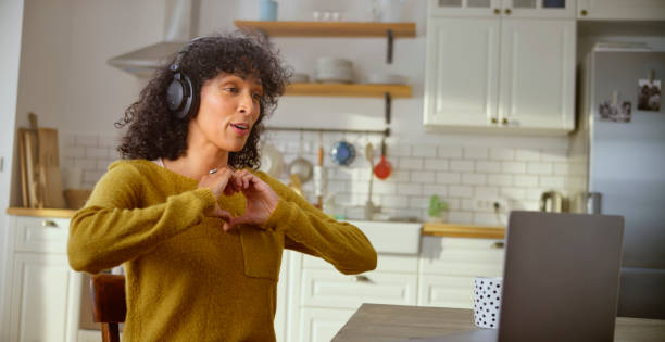 istock Mature woman talking on video call in kitchen 1313800092