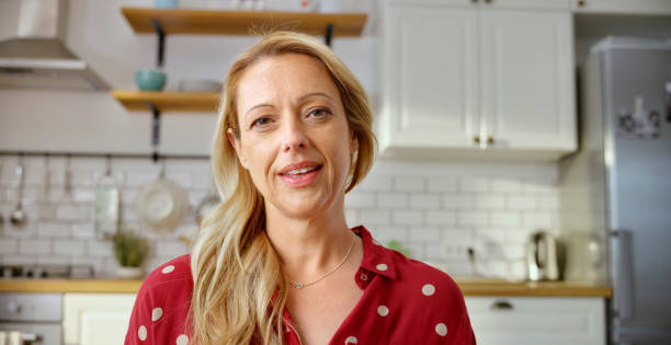 Mature woman having a video call in kitchen
