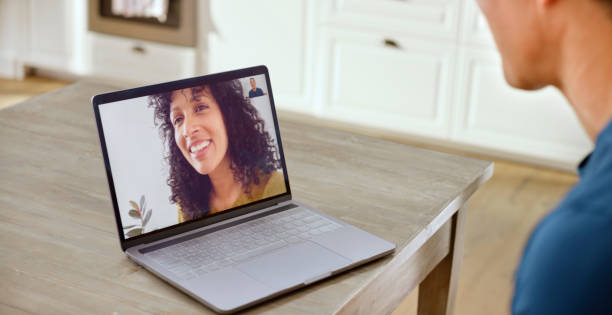 istock Husband talking with his wife on video call 1313800702