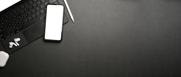 istock Dark creative flat lay workspace with smartphone, digital tablet accessories and copy space 1313801128