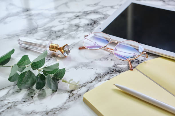 istock White marble office desk table with a lot of thing 1313801502