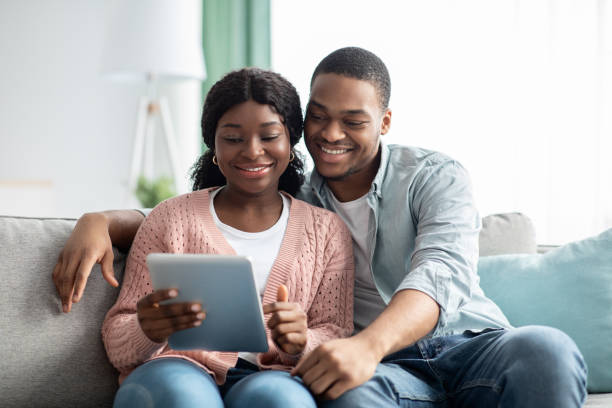 istock Relaxed african american family using digital tablet together 1313801570
