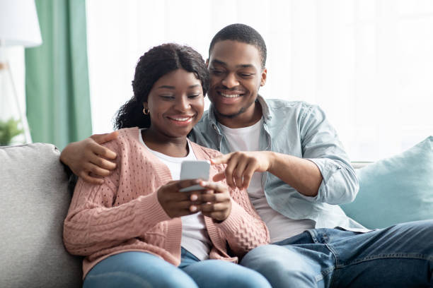 istock Happy black couple checking new shopping application on smartphone 1313802026
