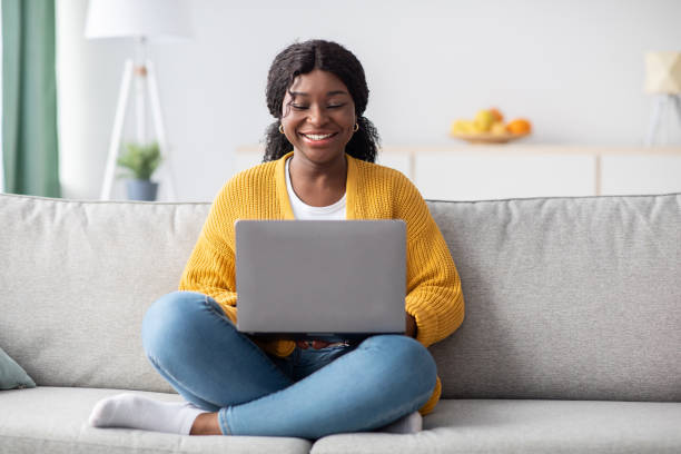 istock Smiling young black woman freelancer working from home, using laptop 1313802800