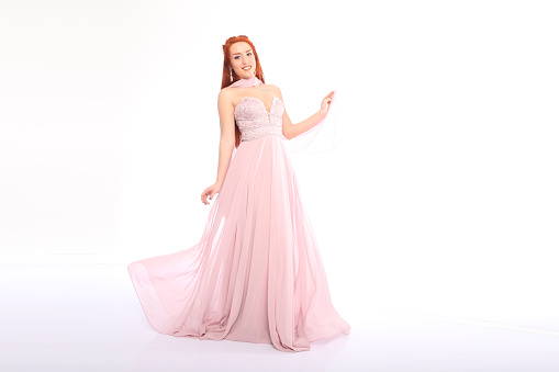 young woman in prom dress. studio shot. on white background. fashion shot.