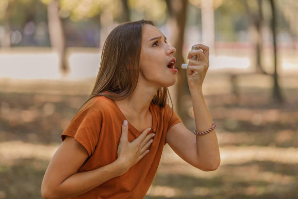 istock A Woman is Using an Asthma Inhaler in Public Park. 1313804873