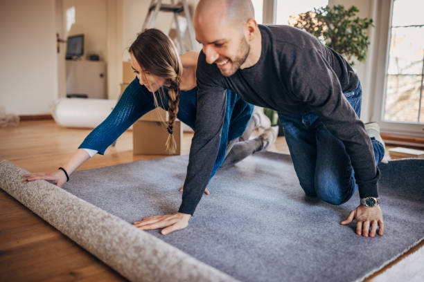 istock Couple unpacking carpet in their new apartment 1313804946