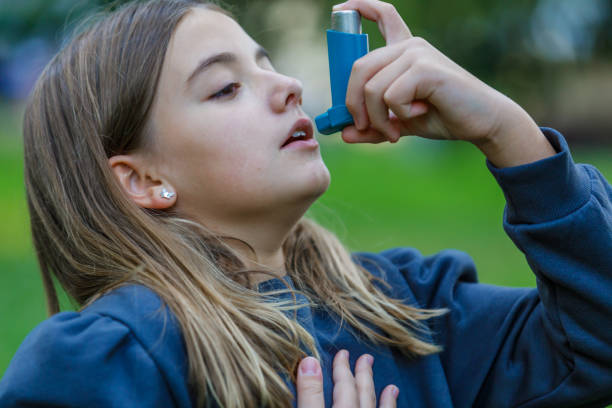 istock Allergic Girl is Walking Outside and Using Asthma Inhaler. 1313805126